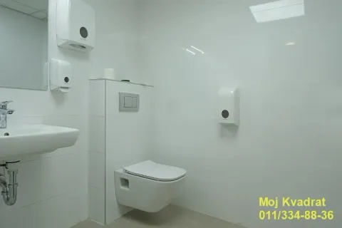 View of a white bathroom with a washbasin and a toilet. - image 18