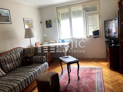 Furnished living room with sofa and television. - image 2