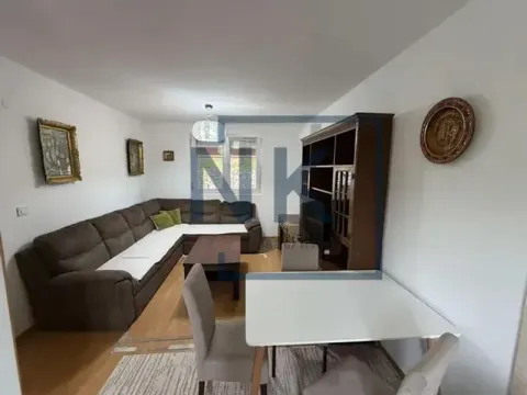 Living room with a sectional sofa, dining table, and wooden furniture. - image 2