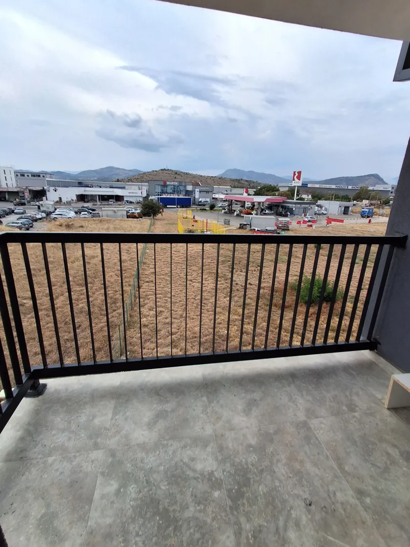 View from the balcony overlooking surrounding buildings and landscape.