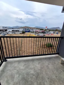 View from the balcony overlooking surrounding buildings and landscape. - image 8