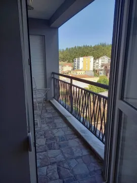 View from the apartment balcony of the surrounding buildings and greenery. - image 9