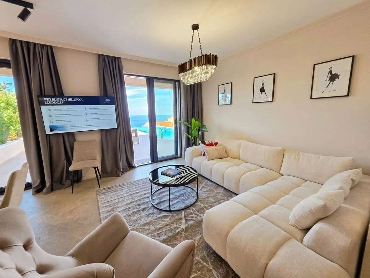 Living room with a large sectional sofa and sea view.