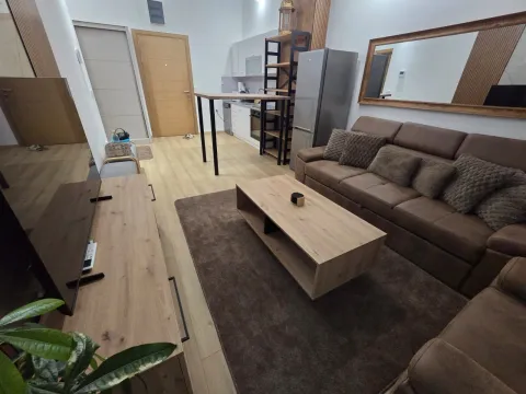 Living room with sofa, TV unit and an open plan layout towards the kitchen. - image 19
