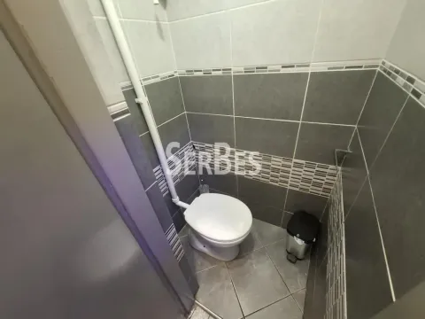Small tiled bathroom with a toilet. - image 18
