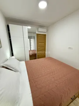 Furnished bedroom with a large double bed and fitted wardrobe. - image 10