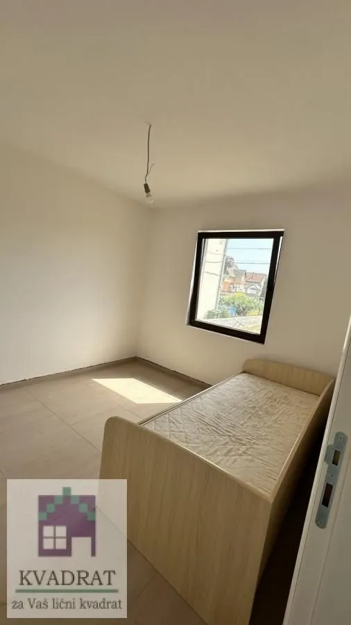 Small room with a bed and a window.