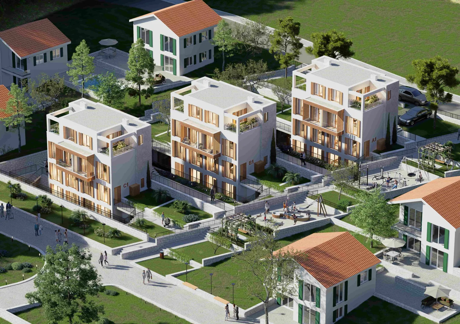 Pogled iz vazduha na kompleks modernih stambenih zgrada sa uređenim dvorištem i igralištem.