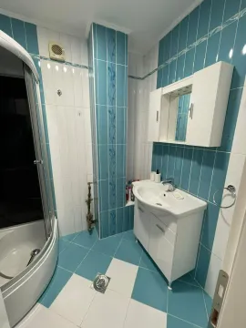Small bathroom with a shower cabin and a white vanity with sink. - image 15