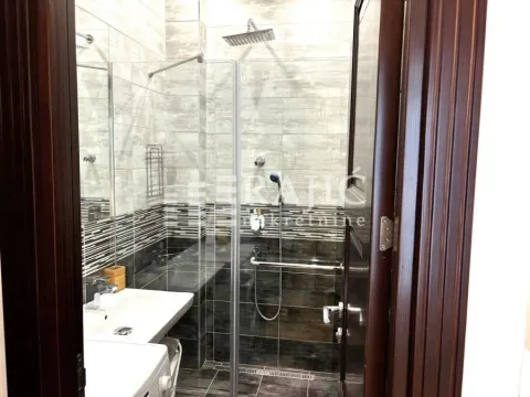 Modernly equipped bathroom with a shower cabin and sink. - image 10