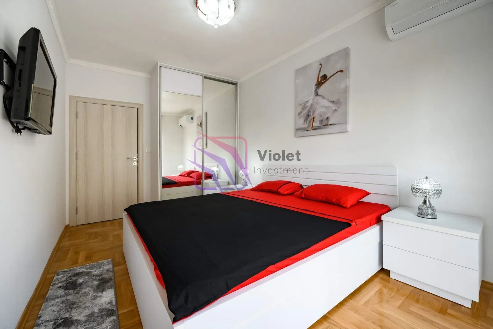Furnished bedroom with a double bed, mirrored wardrobe, and a nightstand.