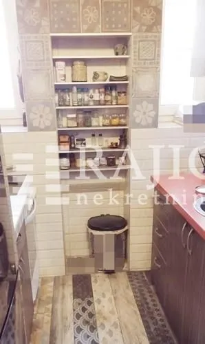Part of the kitchen with built-in shelves and a countertop.