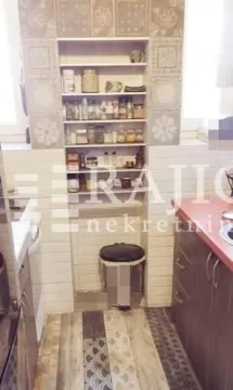 Part of the kitchen with built-in shelves and a countertop. - image 11