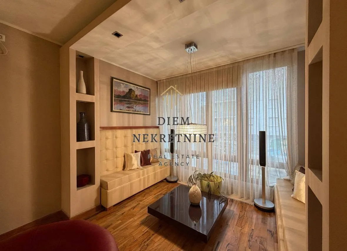 Comfortable living room with seating set and built-in shelving.