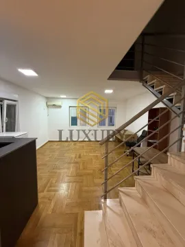 Empty living room with parquet flooring and a staircase. - image 3