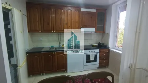 Kitchen with wooden cabinetry, sink, and built-in stove. - image 12