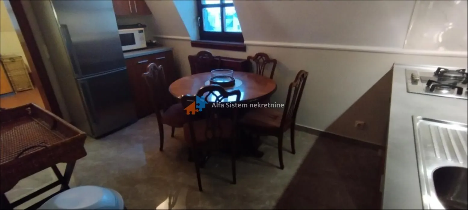 Small kitchen with a dining table and chairs.