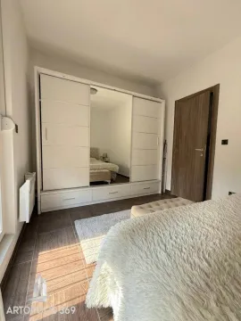 Spavaća soba sa velikim garderoberom sa ogledalom i bračnim krevetom. - image 3