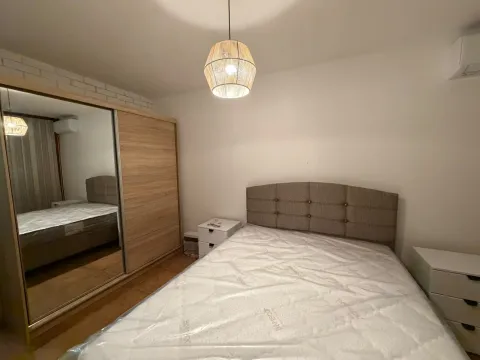 Furnished bedroom with a double bed and a large wardrobe. - image 16