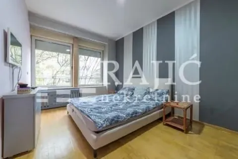 Furnished bedroom with a double bed and windows. - image 12