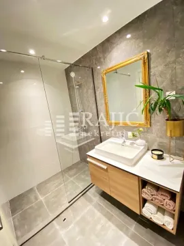 Modern bathroom with a walk-in shower and a vanity unit. - image 11