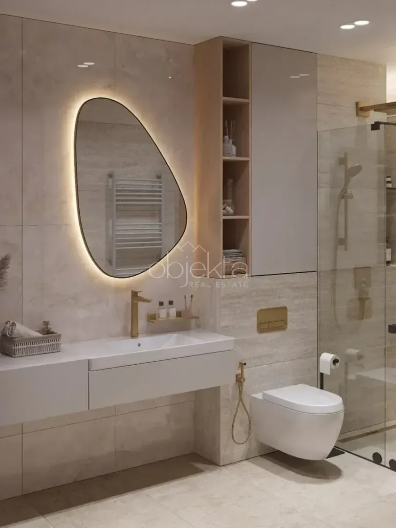 Modern bathroom with a washbasin, toilet, shower enclosure, and backlit mirror.