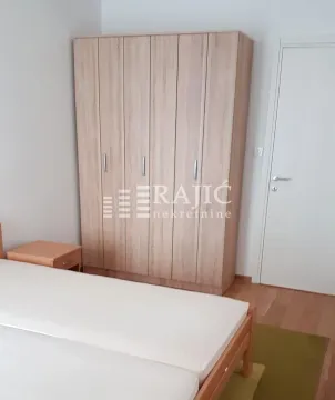 Bedroom with a wooden wardrobe and bed. - image 7