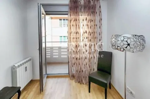 Smaller room with wooden flooring, a chair, and access to the terrace. - image 4