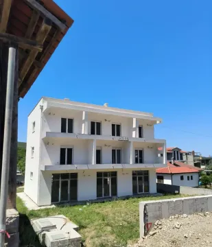 Exterior view of a multi-story residential building under construction with terraces. - image 12