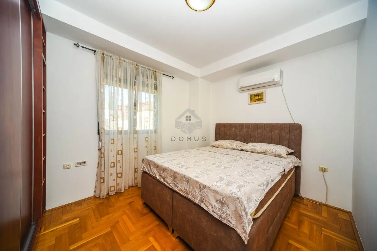Bedroom with a double bed, wardrobe and window.