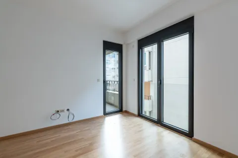 Prazna soba sa parketom i izlazom na balkon. - image 7