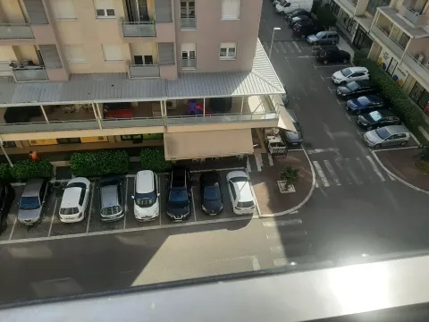 View from the window overlooking the parking lot and adjacent building. - image 12