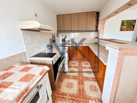 Kitchen with wooden cabinetry and ceramic tile flooring. - image 8