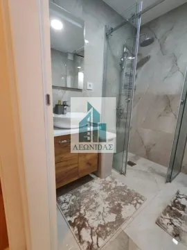 Modernly equipped bathroom with a walk-in shower and a washbasin. - image 13