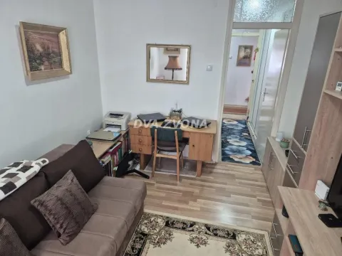 Dnevni boravak sa garniturom za sedenje, radnim stolom i prolazom ka hodniku. - image 6