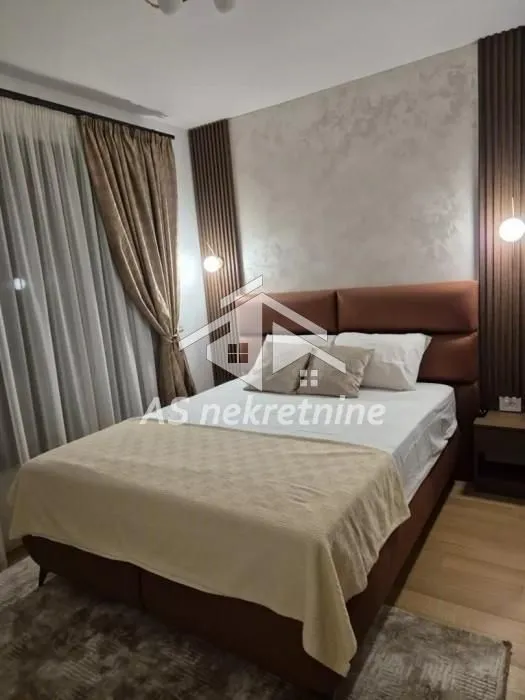 Modern bedroom with a double bed and decorative wall panels.