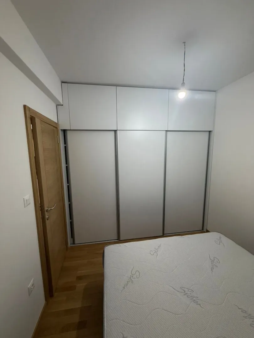 Smaller bedroom with a built-in wardrobe and a bed.