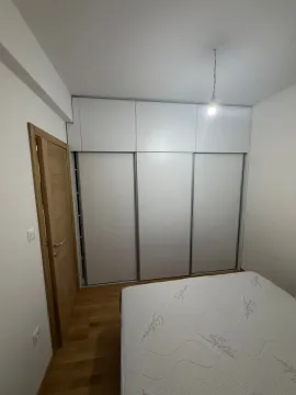 Smaller bedroom with a built-in wardrobe and a bed. - image 14