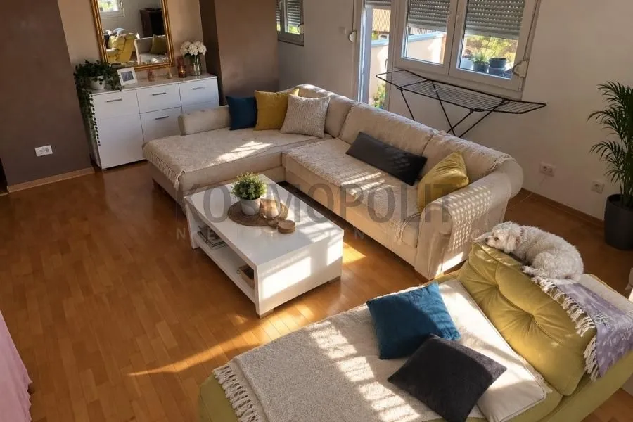 Spacious living room with a sofa set and wooden flooring.