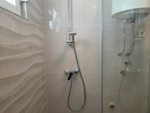 View of a shower cabin with ceramic tiles in a modern bathroom. - image 7