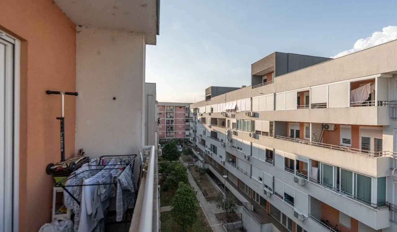 View from the balcony overlooking surrounding apartment buildings and courtyard.