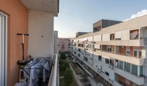 View from the balcony overlooking surrounding apartment buildings and courtyard. - image 11