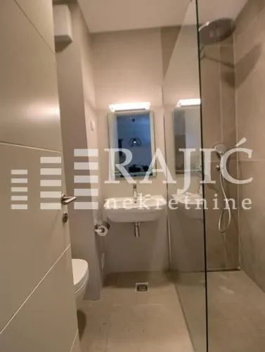 Modernly equipped bathroom with a walk-in shower.