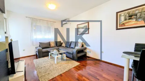 Living room with sofa, coffee table, TV and dining area. - image 3