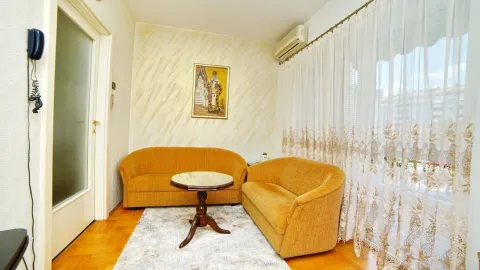 Living room with two yellow sofas and a wooden coffee table. - image 16