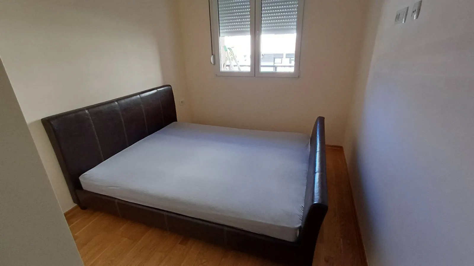Bedroom with a double bed and a window.