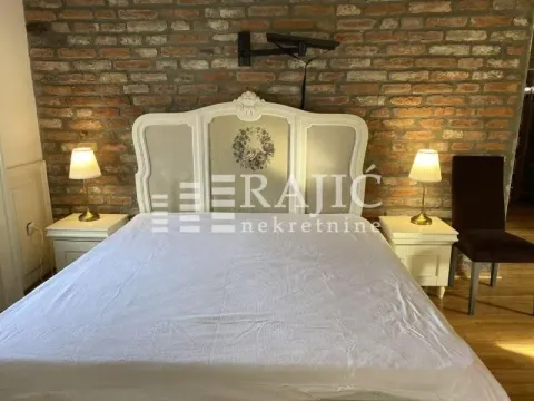 Bedroom with a double bed and a decorative brick wall. - image 16