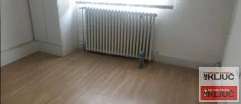 Empty room with laminate flooring and a radiator under the window. - image 7