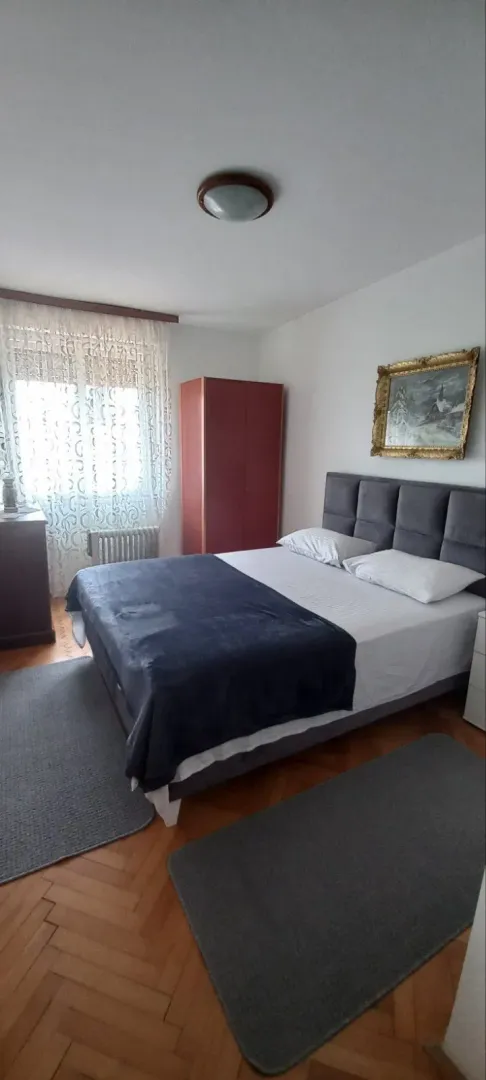 Bedroom with a double bed and a wardrobe.
