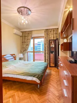 Furnished bedroom with a double bed, wooden parquet flooring, and access to the terrace. - image 8